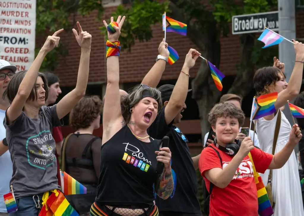OC Pride parade spectators Becca Wilhelm, left, and Ryann Crofoot,...