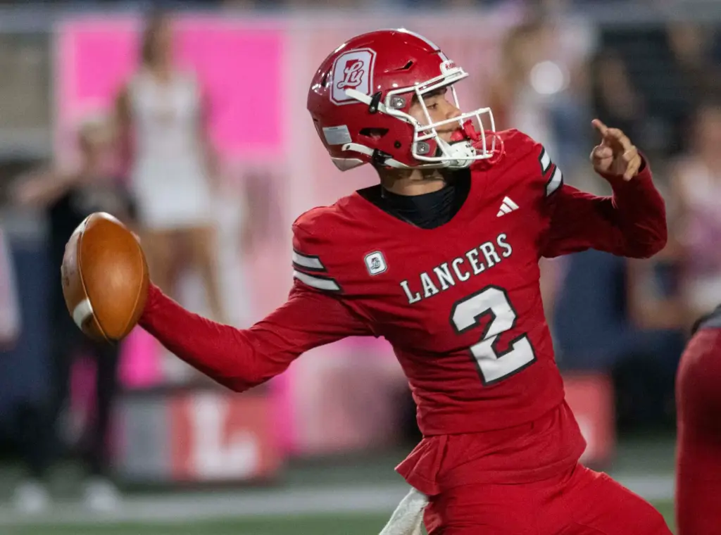 Orange Lutheran’s Reagan Toki (2) passes during a high school...