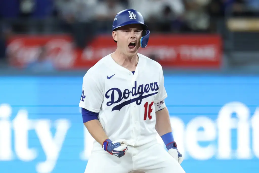 The Dodgers’ Will Smith celebrates at second base after hitting...