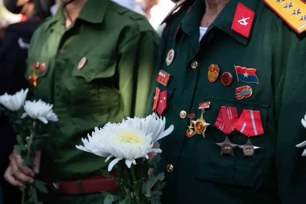 People watch as remains are transferred for burial at Vietnam's Martyr's Cemetery.