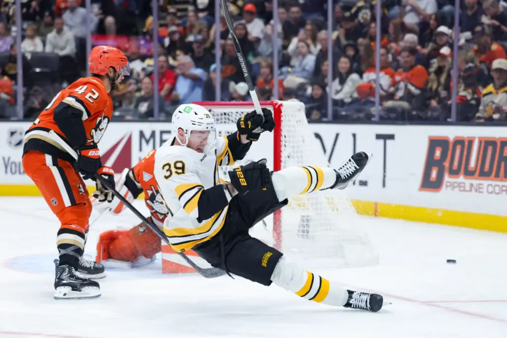Boston Bruins center Morgan Geekie reacts as he falls to...