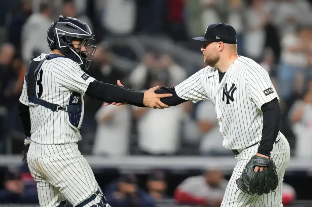 New York Yankees catcher Austin Wells, left, greets relief pitcher...