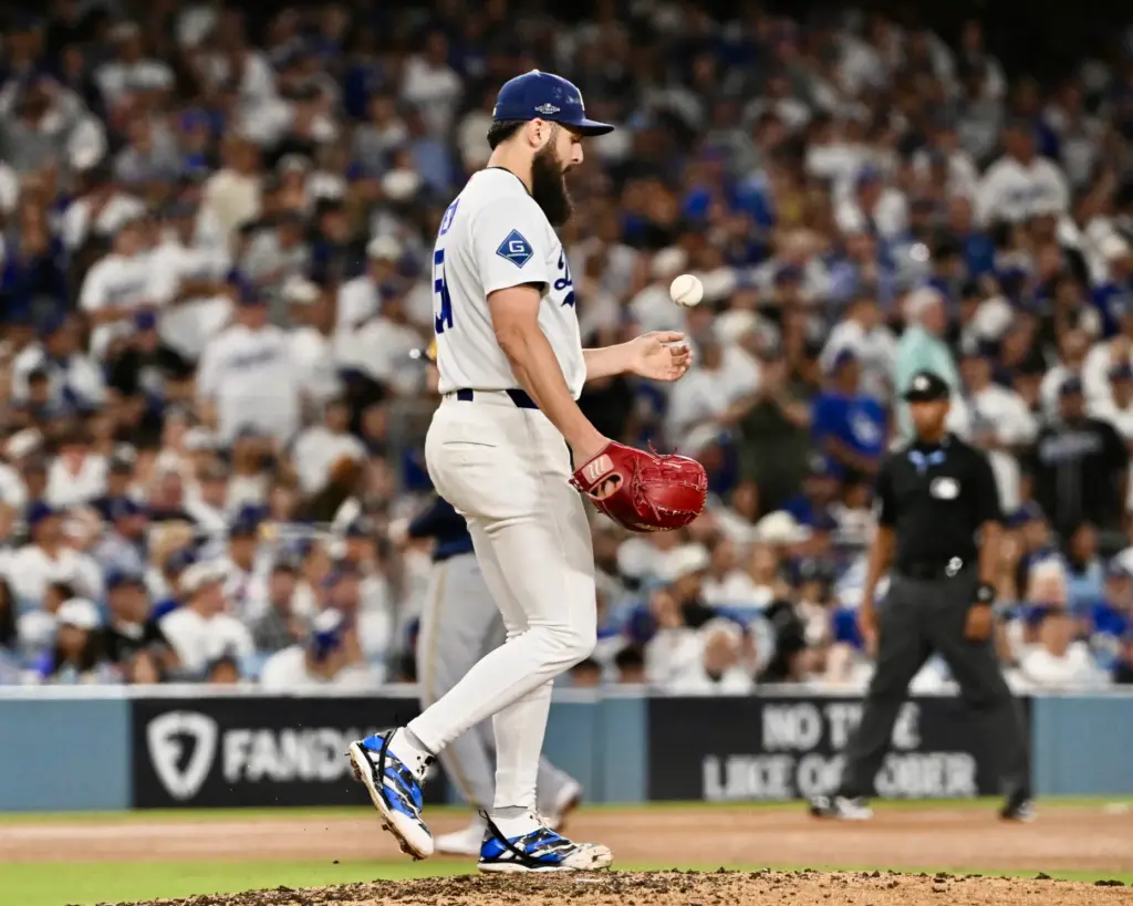 Dodgers relief pitcher Alex Vesia tosses a baseball after walking...