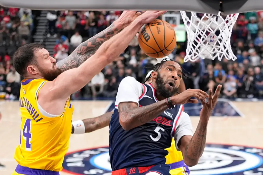 Clippers forward Derrick Jones Jr., right, has his shot blocked...