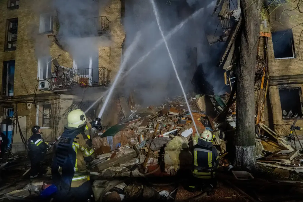Firefighters put out a fire following a Russian air attack on a residential building.