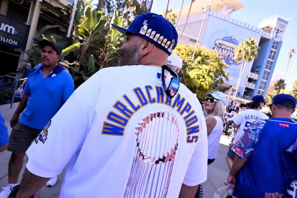 A fan shows off his World Series hat and jersey...