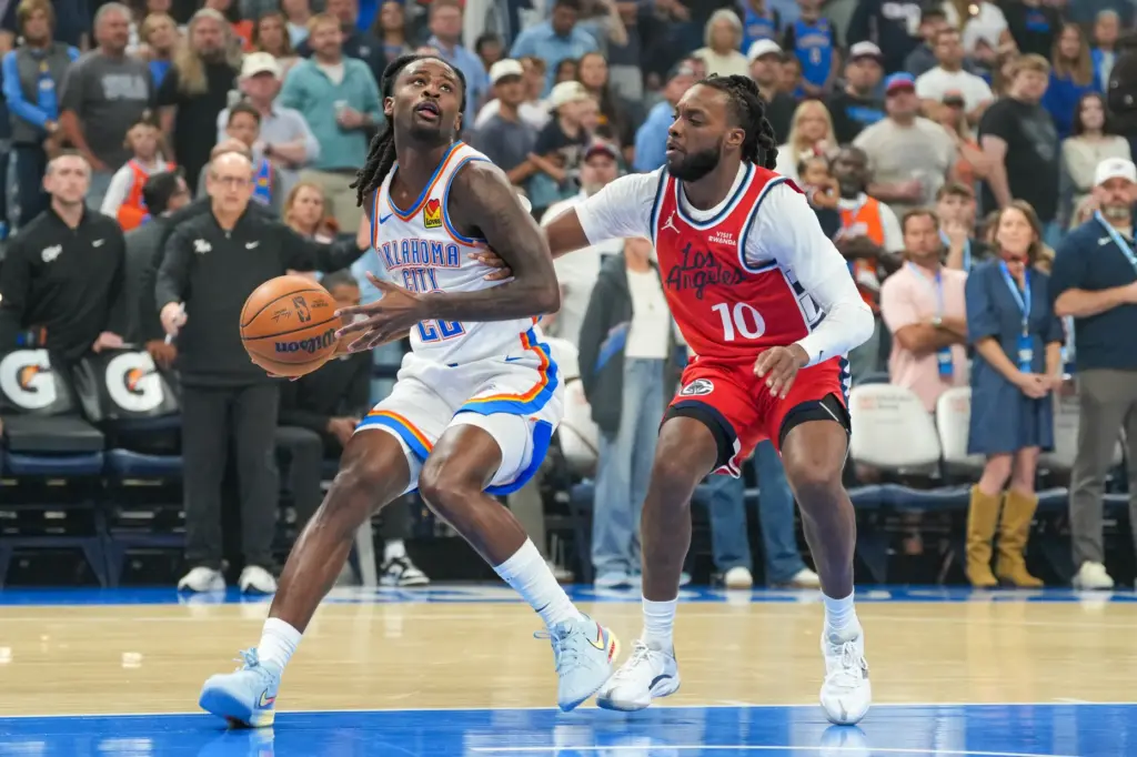 Oklahoma City Thunder guard Cason Wallace, left, drives past Clippers...