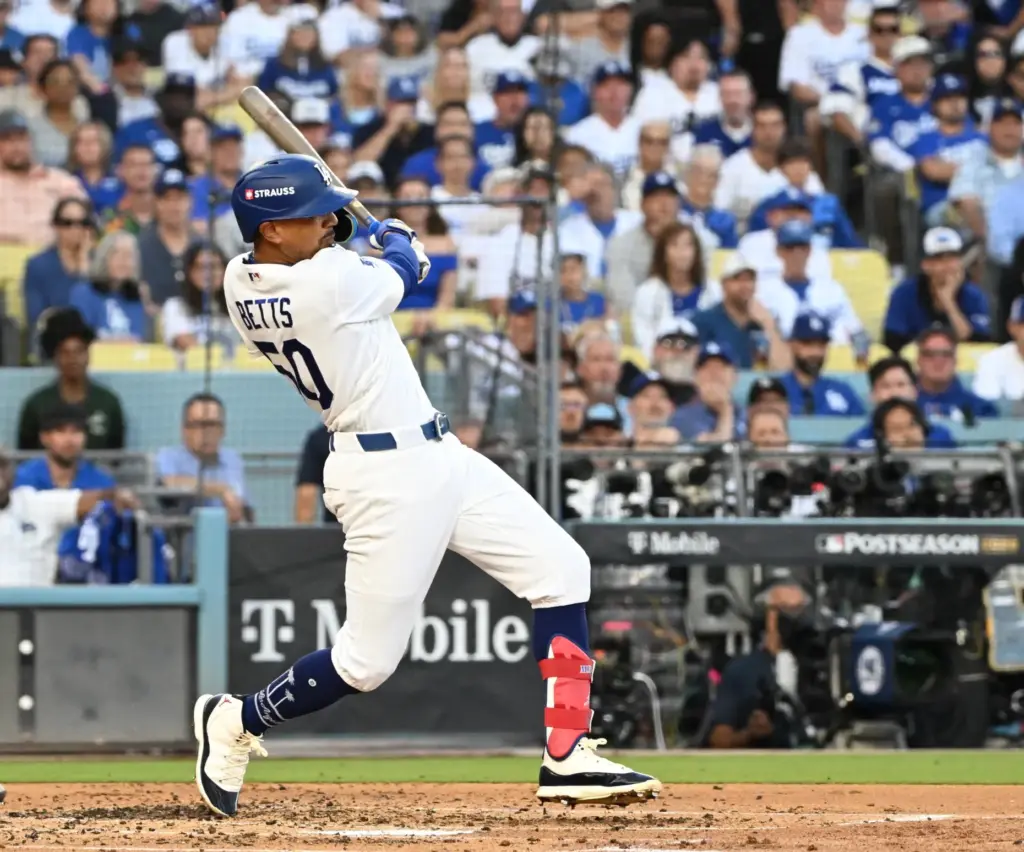 The Dodgers’ Mookie Betts hits a single during the third...