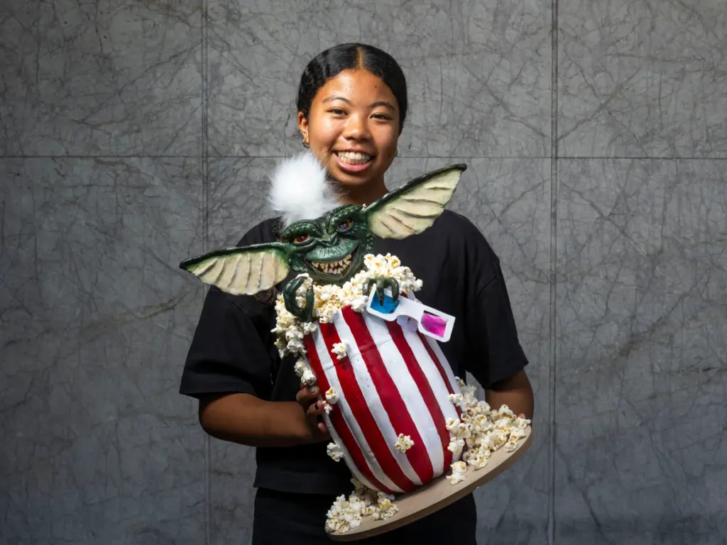 Jupiter Thompson holds her pumpkin titled âGremlin âStripeââ which she...