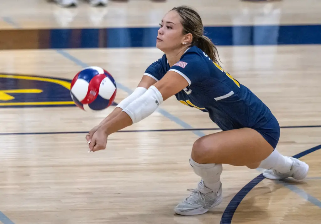 Crean Lutheran defensive specialist Caroline Park (21) digs the ball...