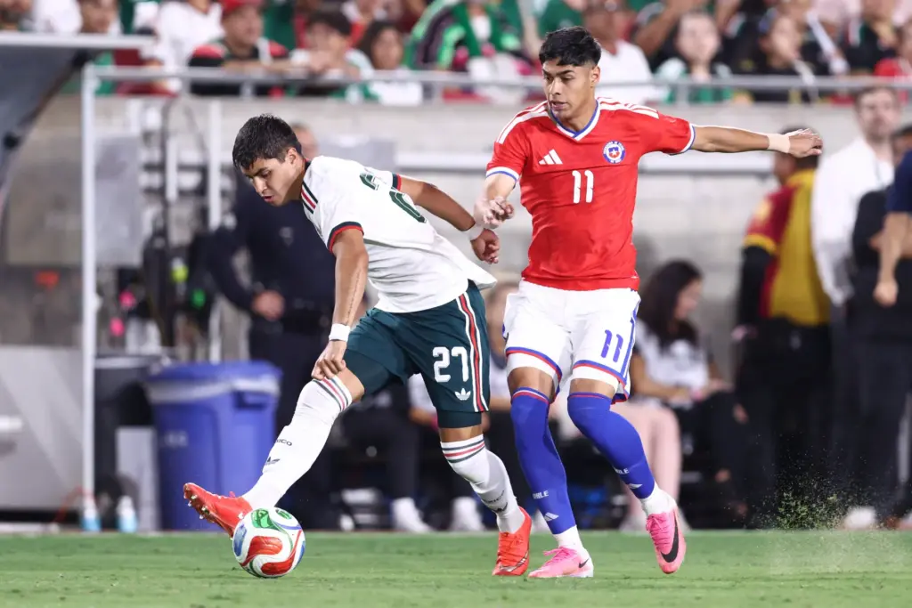 Mexico defender Everardo LÃ³pez, left, kicks the ball while defended...