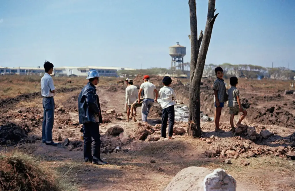 People watch as remains are transferred for burial at Vietnam's Martyr's Cemetery.