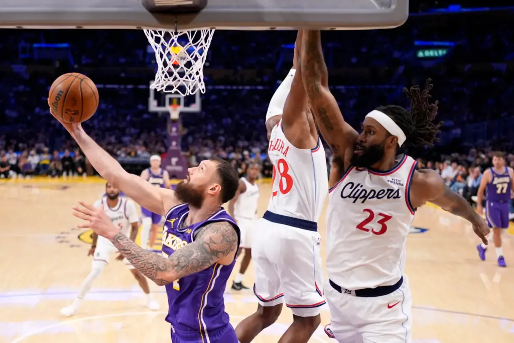 Lakers forward Sandro Mamukelashvili, left, shoots as Clippers forward Rui...