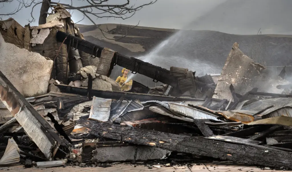 Firefighters put out hot spots at a home on Via...
