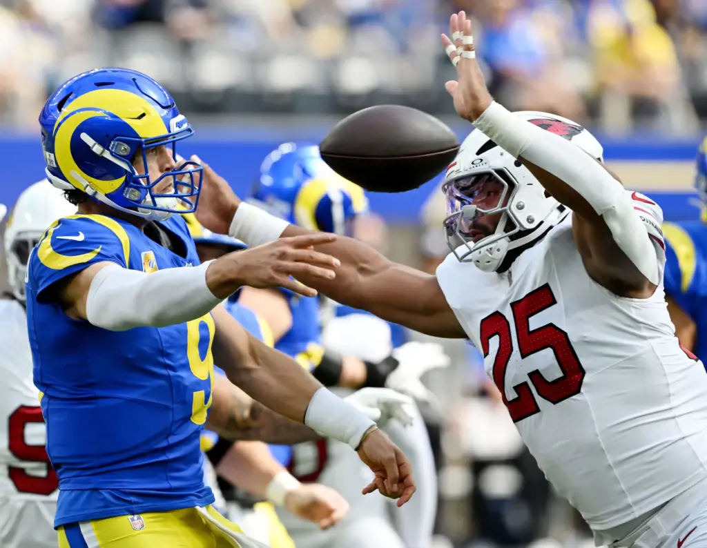 Rams quarterback Matthew Stafford (9) passes under pressure from Arizona...