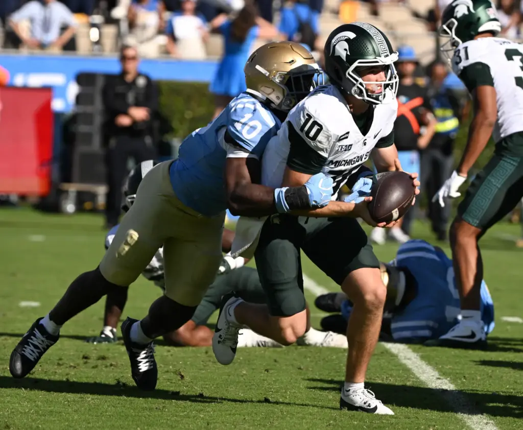 UCLA linebacker Sammy Omosigho (10) sacks Michigan State quarterback Kayd...