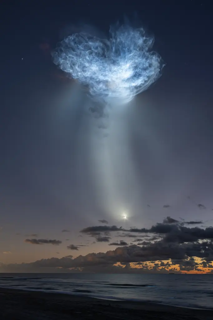 The exhaust plumes of a SpaceX Falcon 9 rocket carrying...