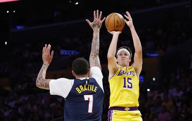 Lakers guard Austin Reaves takes a shot as Denver Nuggets...