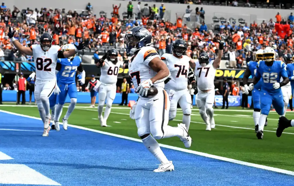 Denver running back J.K. Dobbins (27) scores on a short...