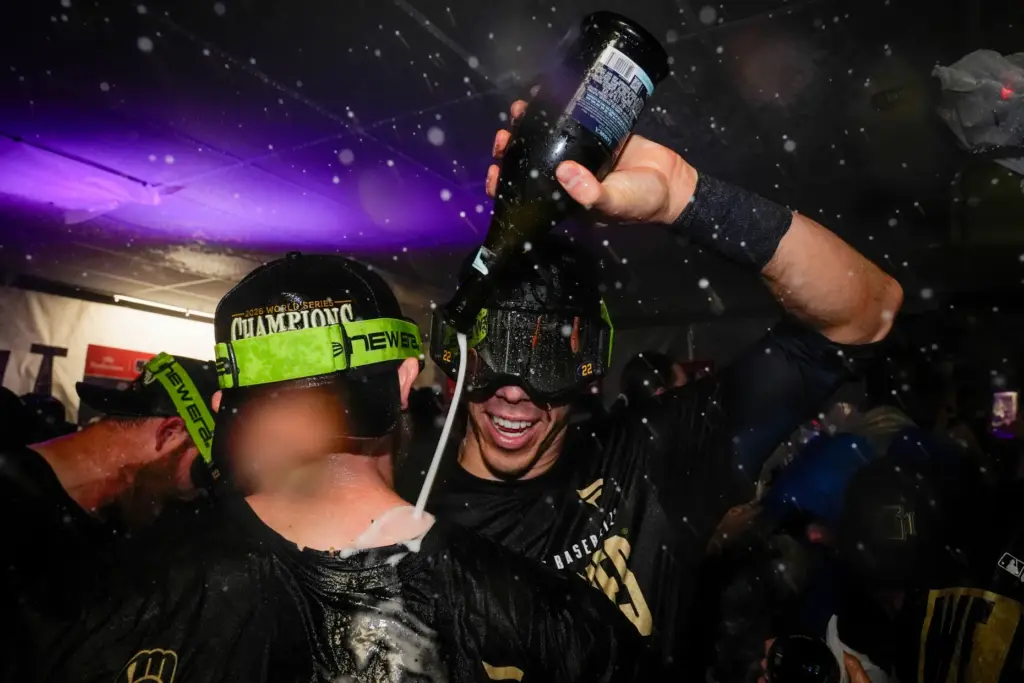 Milwaukee Brewers designated hitter Christian Yelich, right, celebrates with teammates...