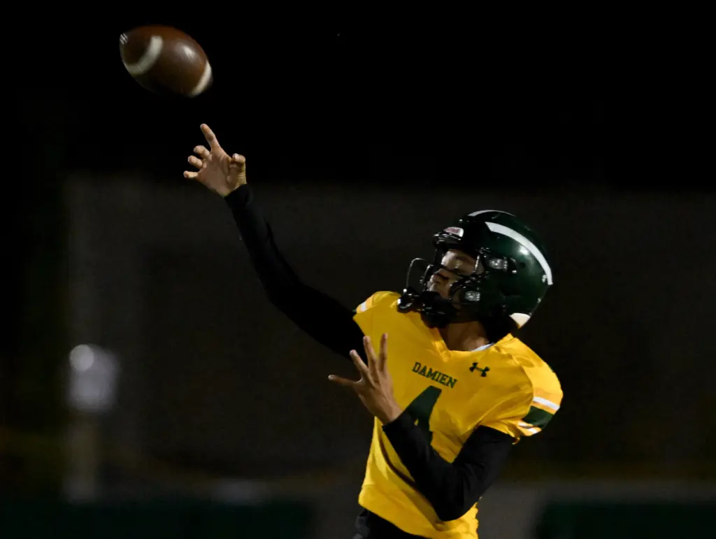 Damien Spartans quarterback Anthony Randolph (4) makes a pass during...