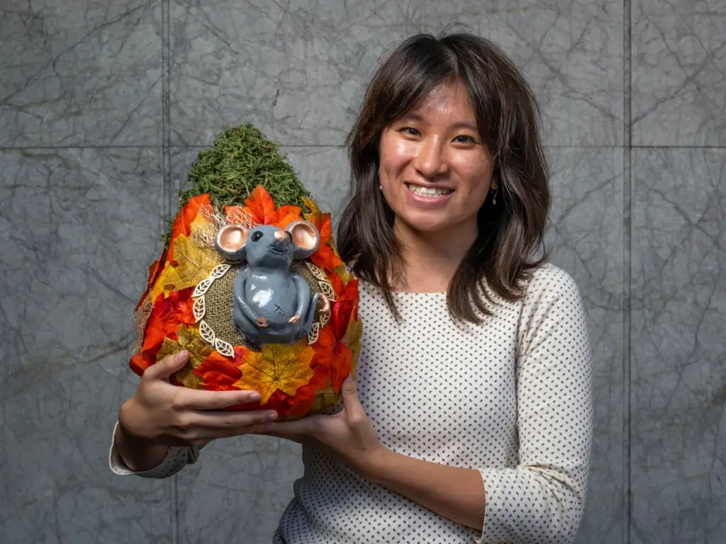 Angelyn Pratana holds her pumpkin titled âRatâs Cozy Cottageâ which...