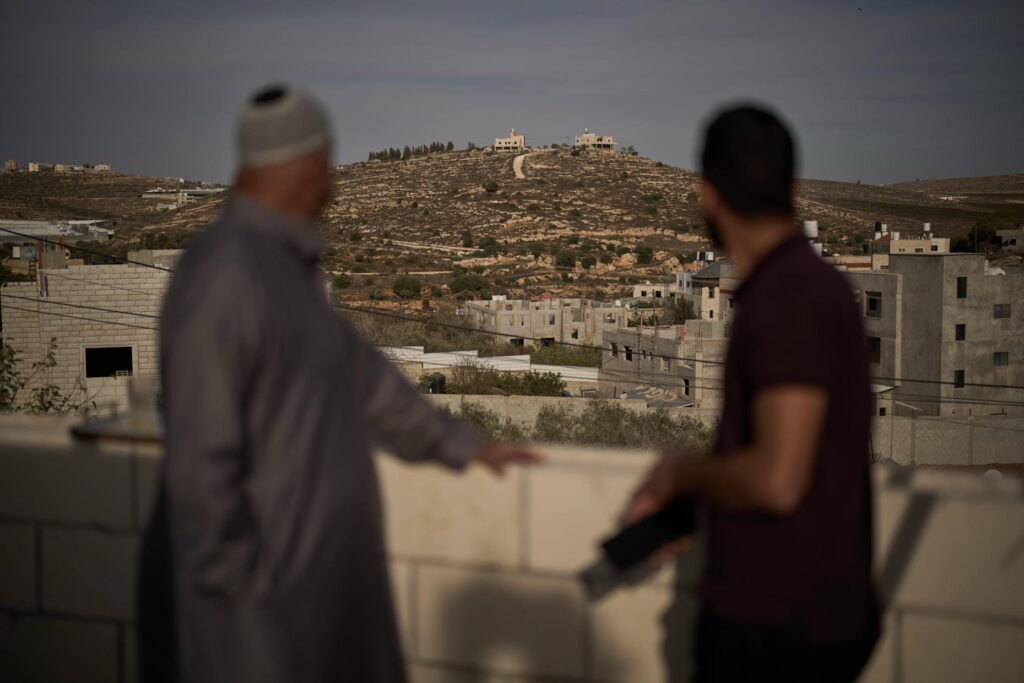 Mahmoud Tubasi, left, and his son Wael, over look their...