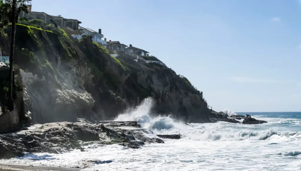 Waves crash on the rocks at the south end of...