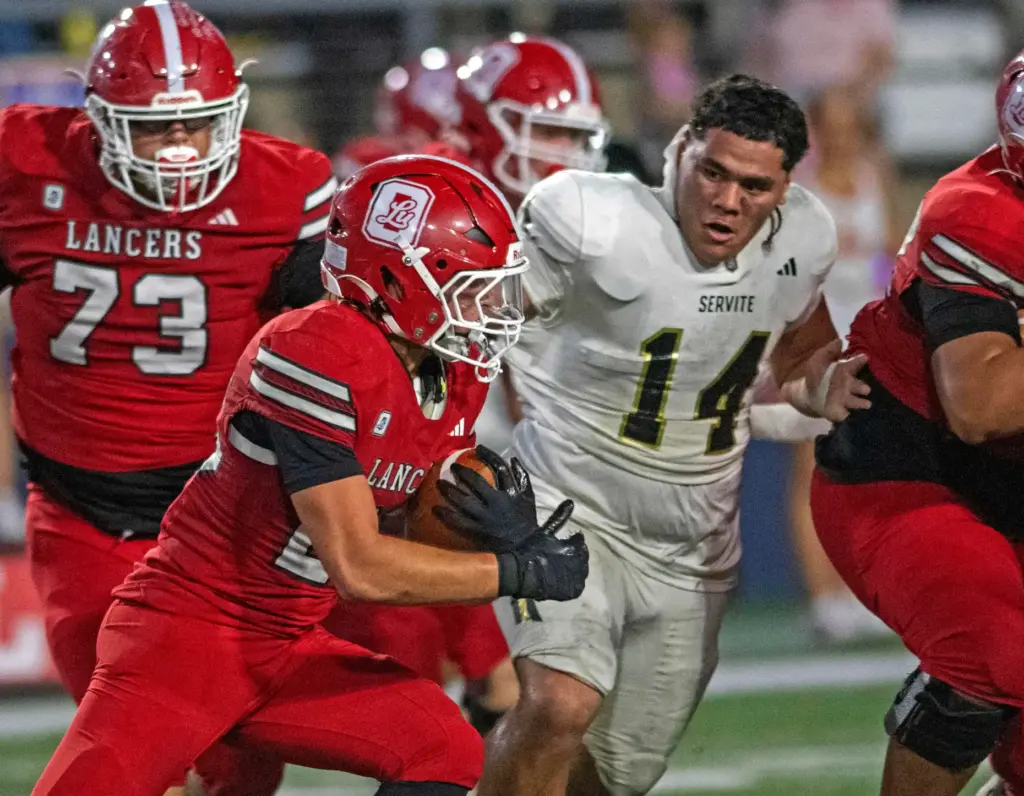 Serviteâs Hansen Makaafi (14) chases down Orange Lutheran’s Ryan Christianson...