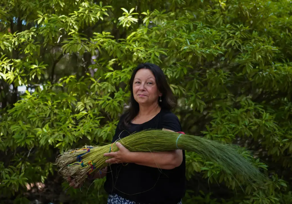 Jennifer Neptune, citizen of the Penobscot Nation, holds a bundle...