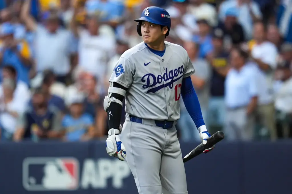 Dodgers designated hitter Shohei Ohtani walks to the dugout after...