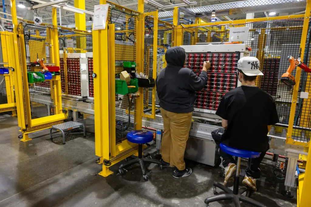 Employees work inside Viridi’s battery system manufacturing plant in Buffalo,...