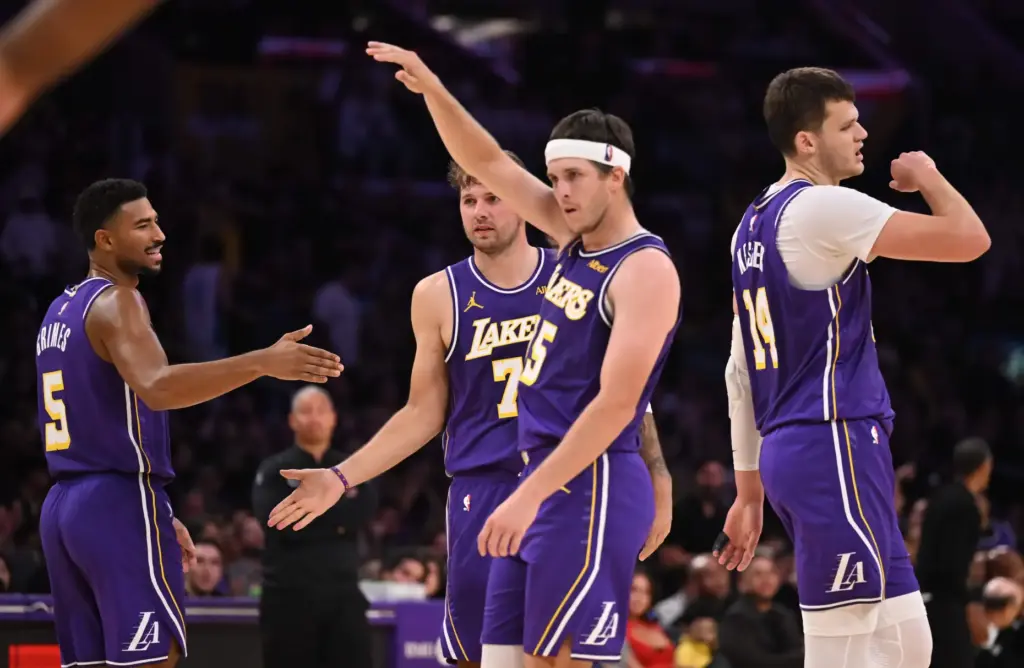 Lakers guard Austin Reaves, middle, celebrates with Luka Doncic (77),...