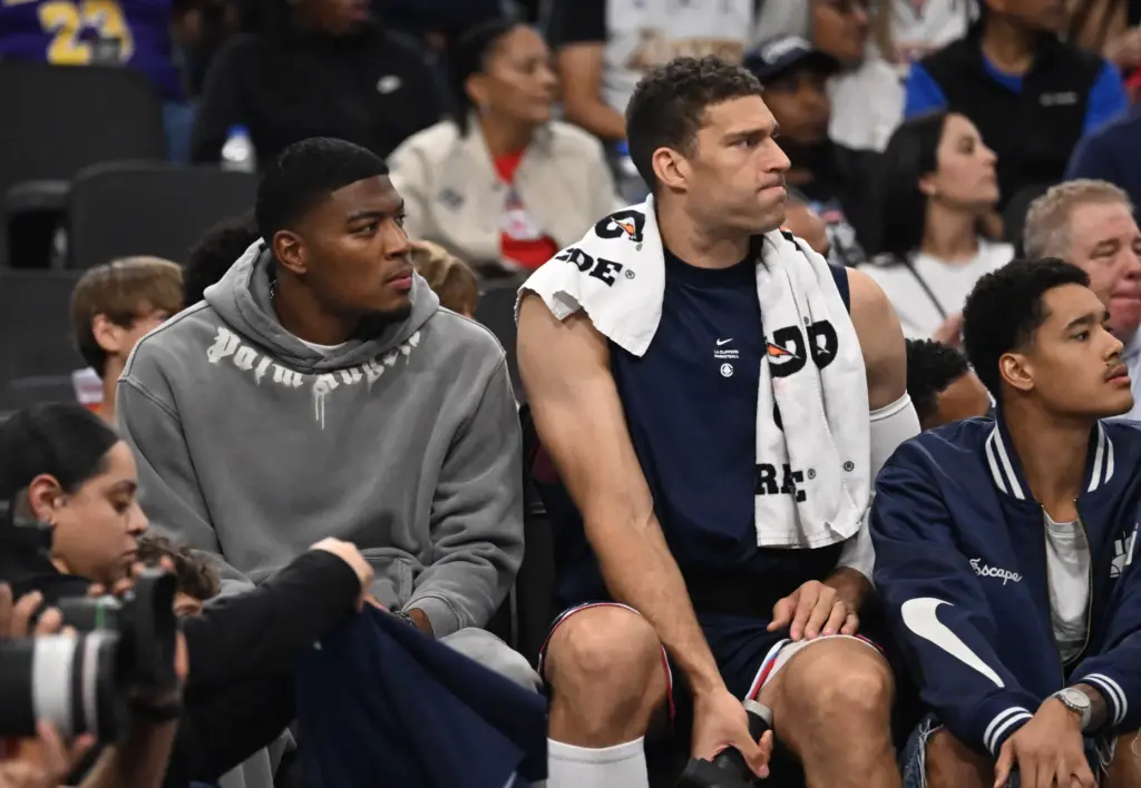 Clippers forward Rui Hachimura, left, and center Brook Lopez watch...