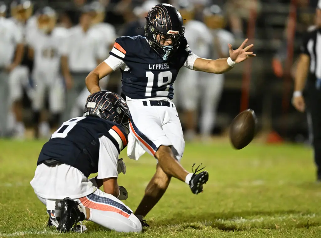 Peter Batsaras #19 of Cypress kicks an extra point in...