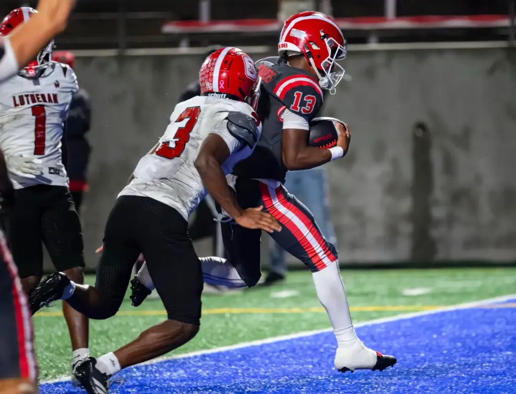 Mater Dei quarterback Paytyn Guess, right, runs into the end...