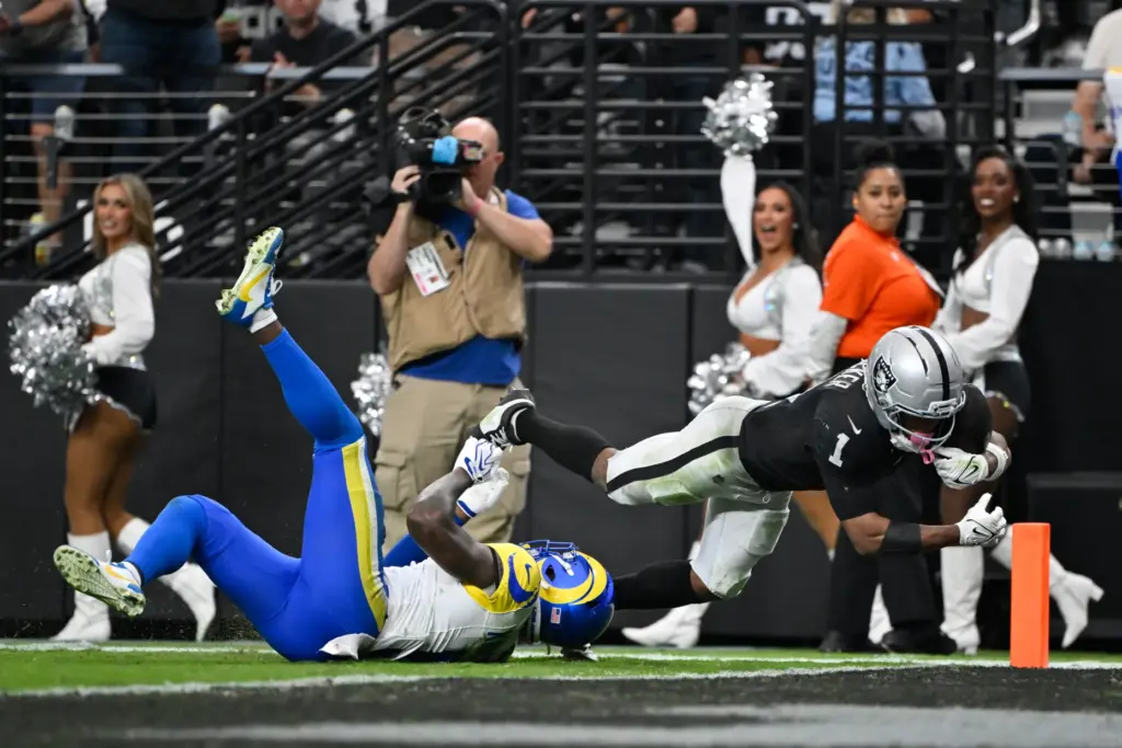 Las Vegas Raiders wide receiver Tre Tucker (1) dives in...