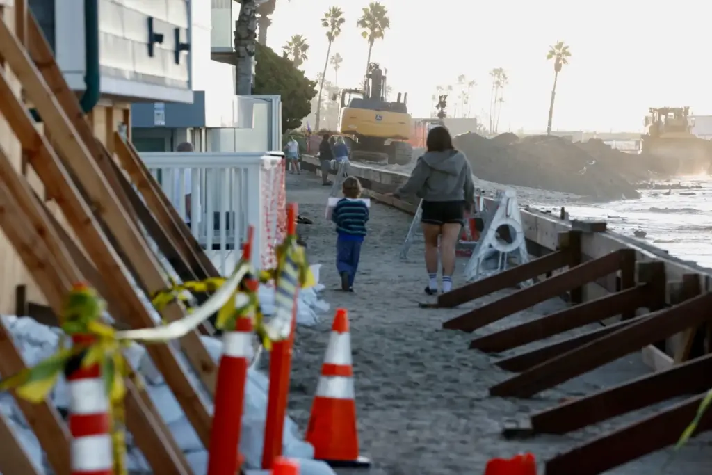 Dredging to replace sand on the beach near the battered...