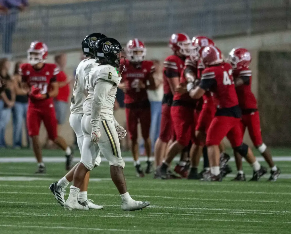 Orange Lutheran’s defense celebrates after recovering Serviteâs Benjamin Harris (6)...