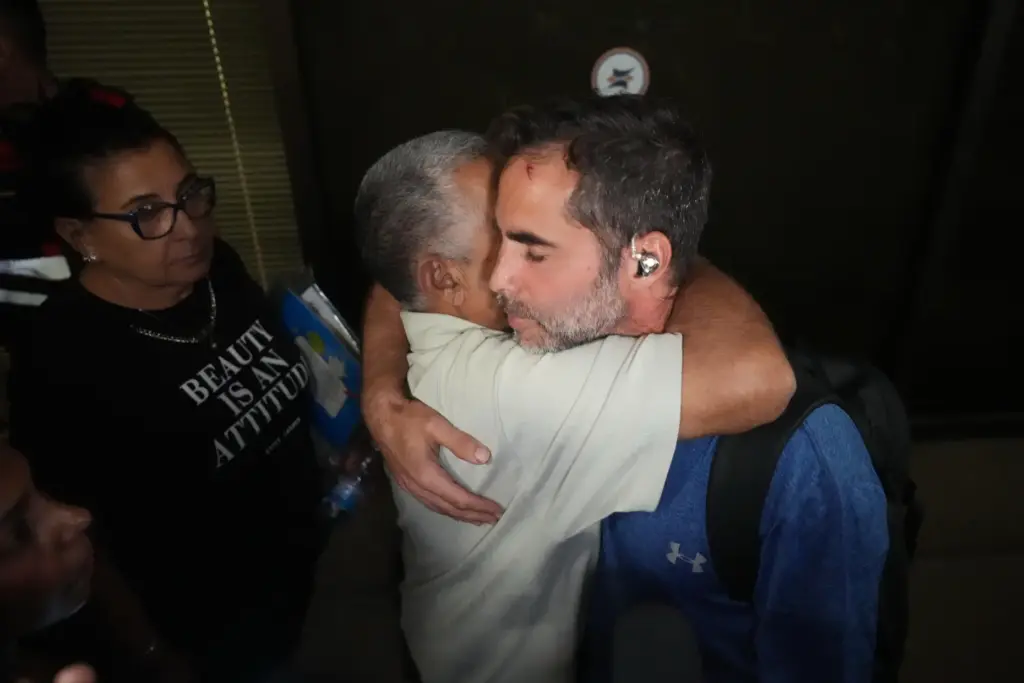 Israeli passenger Asaf Rajuan, right, who experienced an emergency landing...