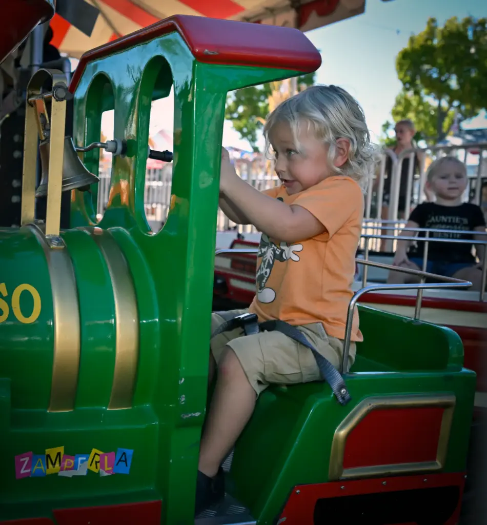 Asher McKinion rings the bell while riding a train on...