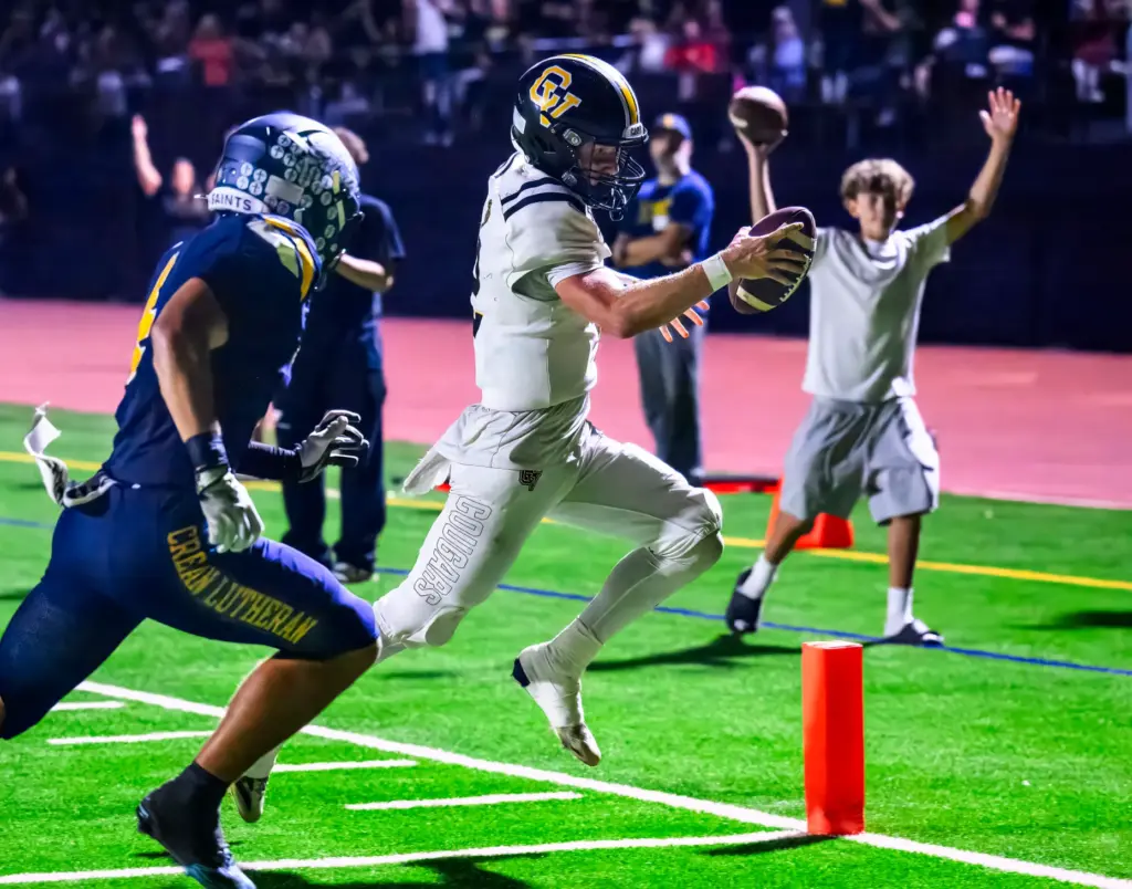 Capistrano Valley quarterback Talon Spencer, right, crosses the goal line...