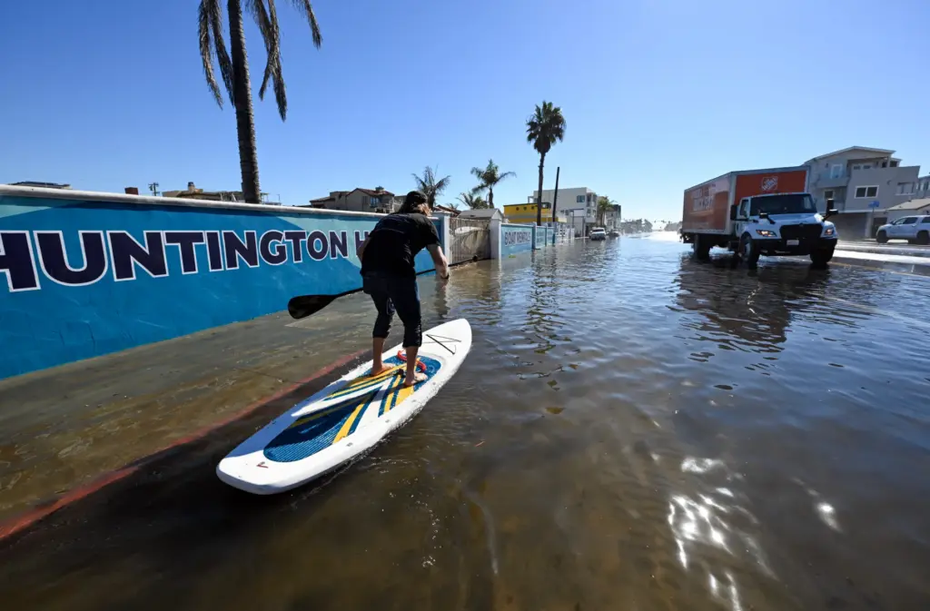 Casey Satchell rides a stand up paddle board as sea...