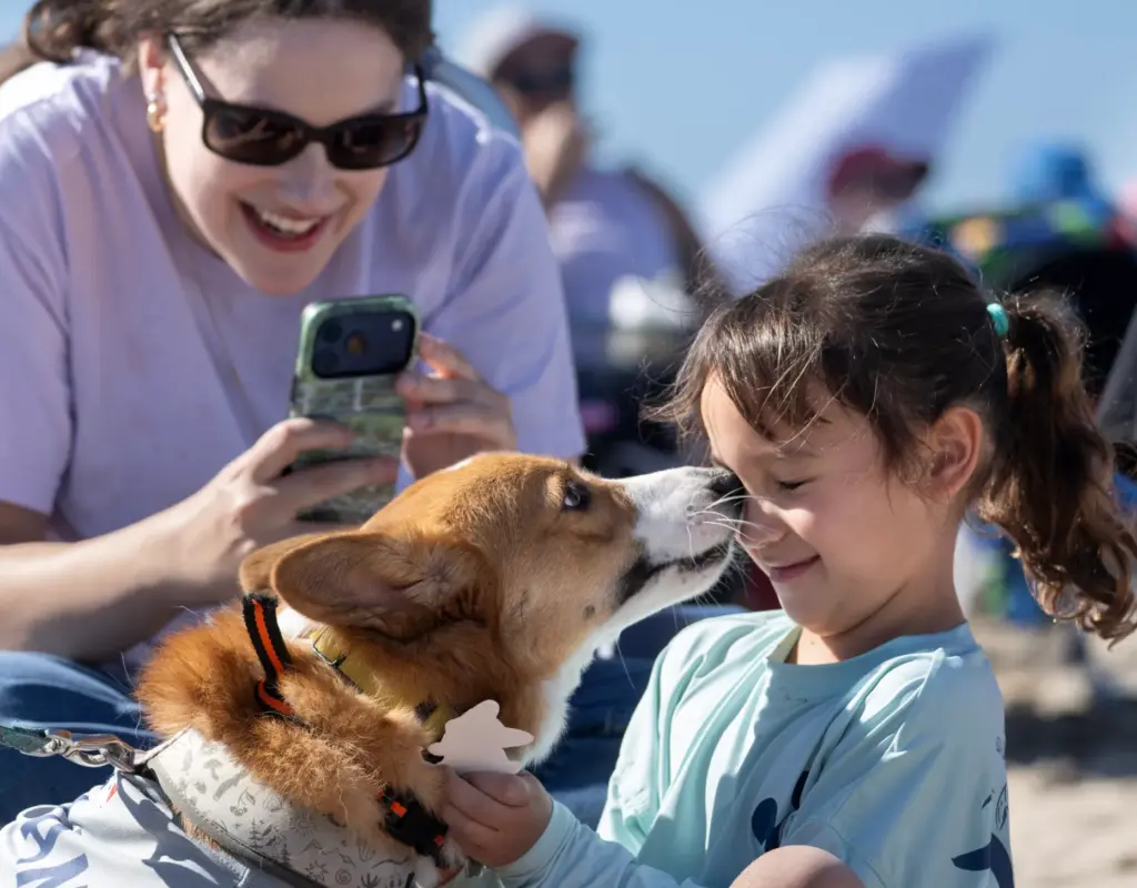 Six-year-old Aida Lin gets a kiss from Georgie, a visitor,...