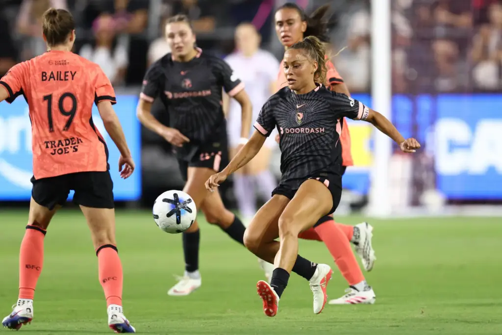 Angel City FC defender Sarah Gorden, right, chases the ball...