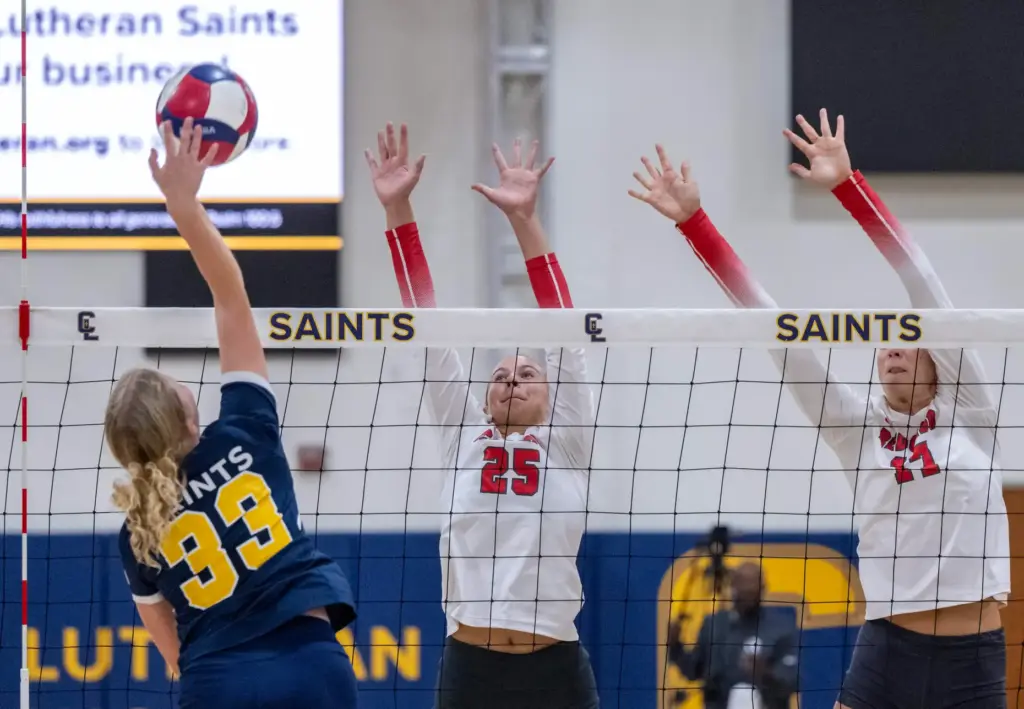 Crean Lutheran outside hitter Sadie Robinson (33), left, hits the...