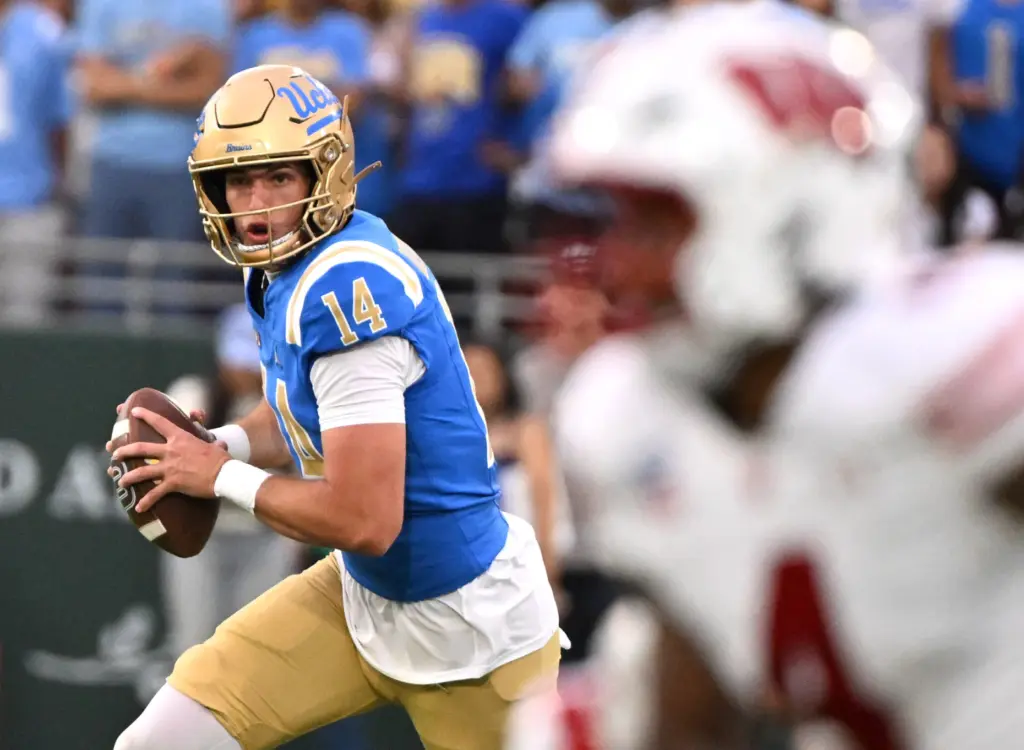 Quarterback Ty Dieffenbach #14 of the UCLA Bruins prepares to...