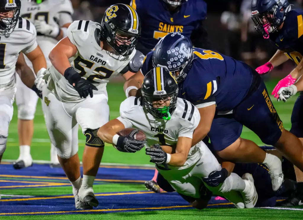Capistrano Valley wide receiver Brody Saavedra dives forward for a...