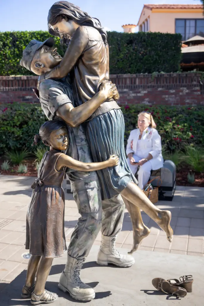 Gold Star Mother Penny Bento sits behindÂ a 600-pound bronze statue,...