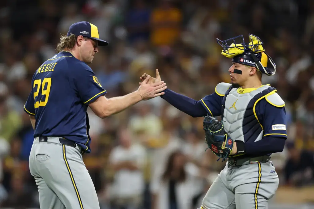 Milwaukee Brewers relief pitcher Trevor Megill, left, and catcher William...